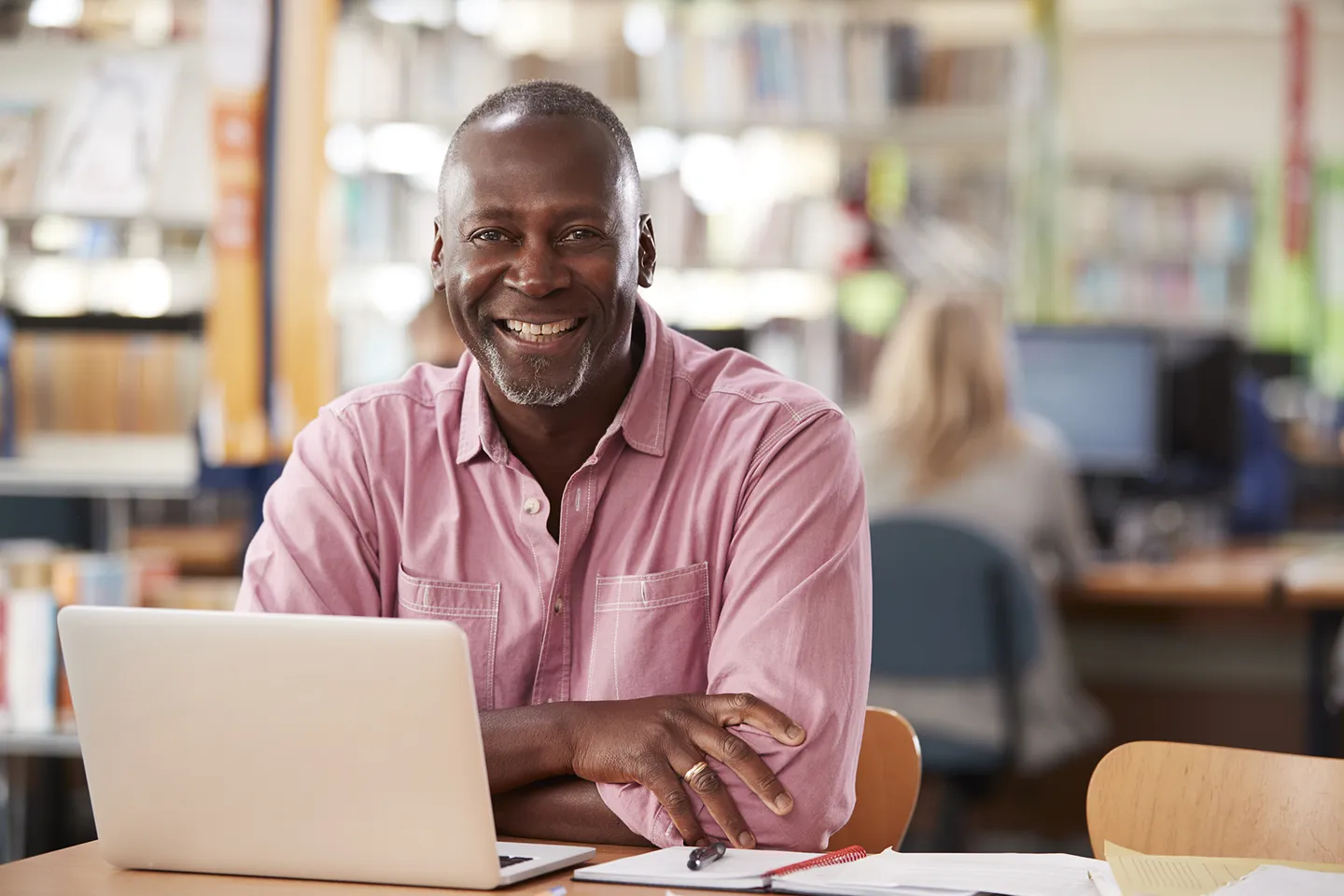 Man sitting at a laptop and smiling