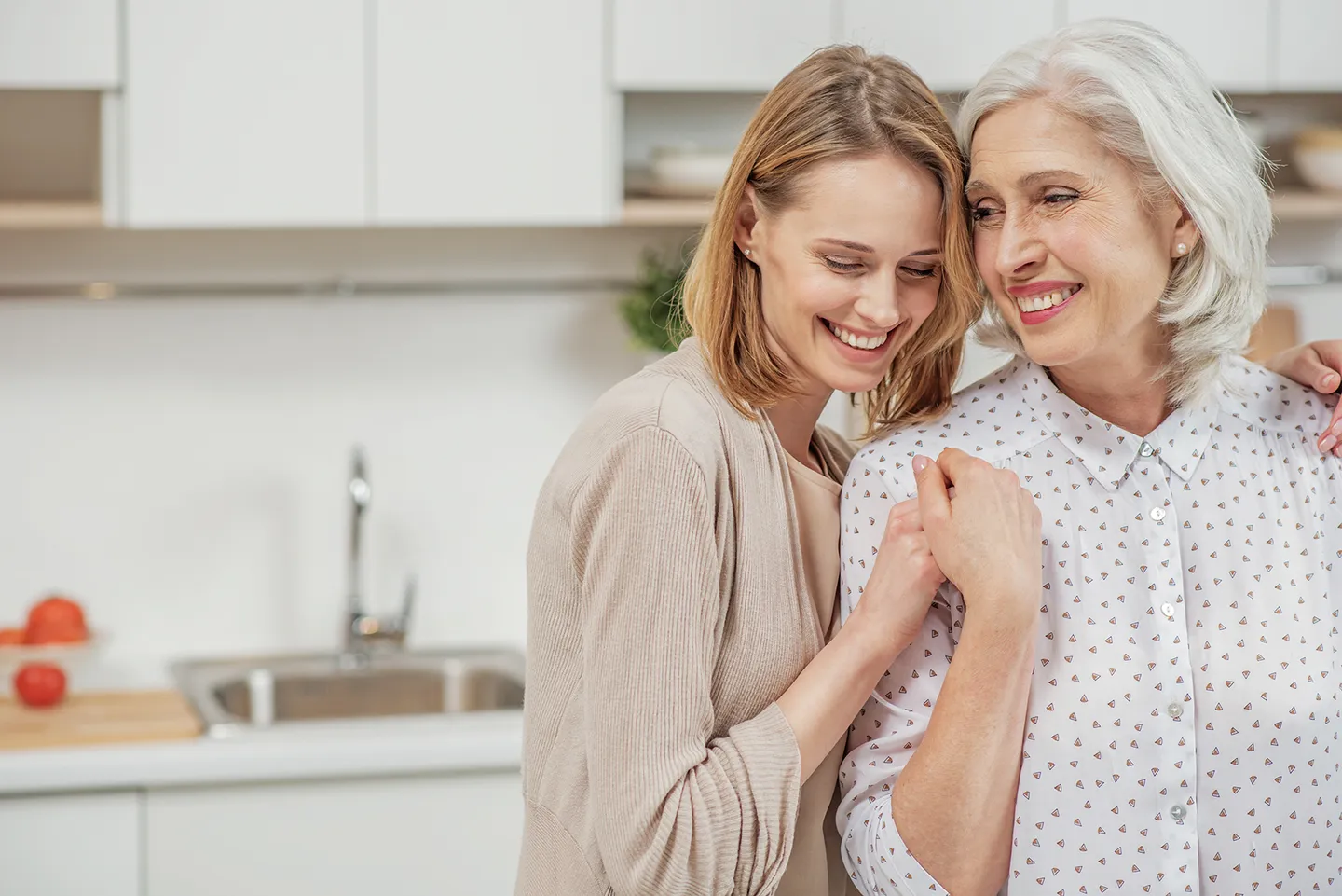 Younger woman hugging older woman