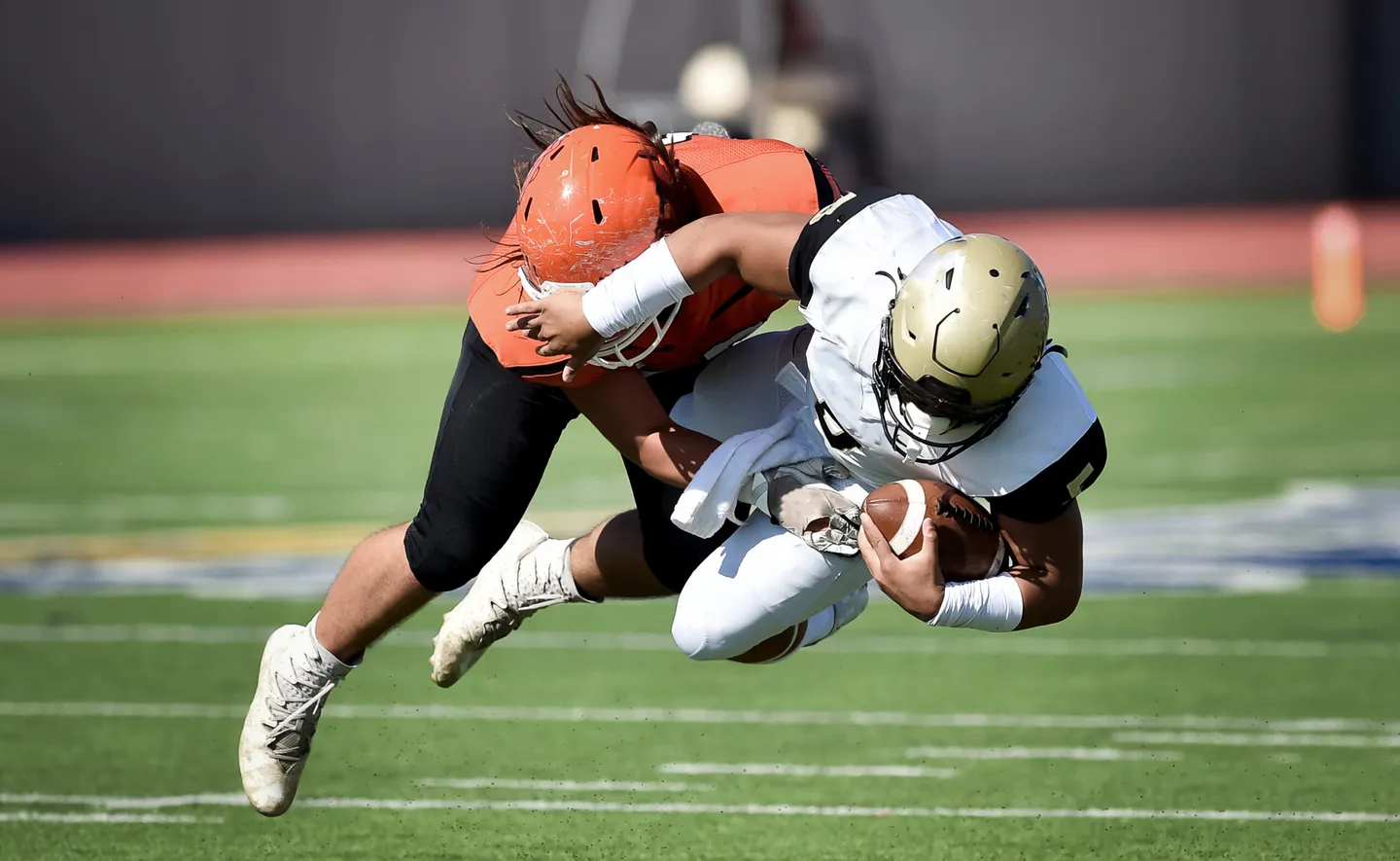 Football players demonstrating concussion risk in sports