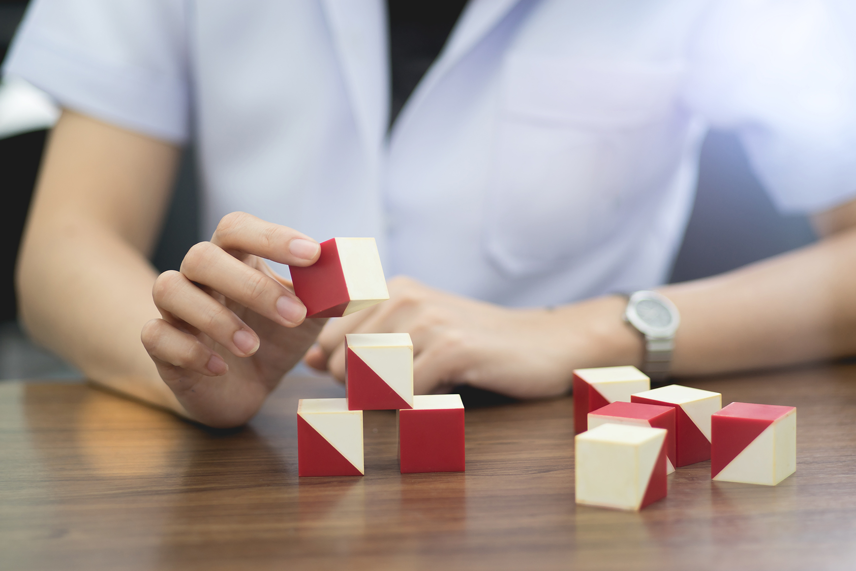 hands stacking WISC-V blocks